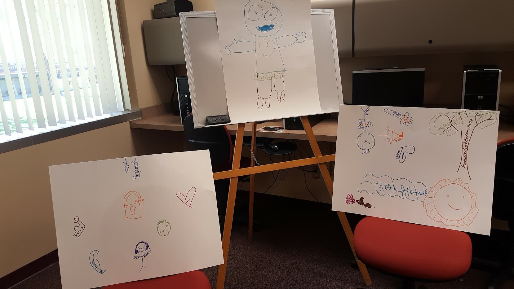 Ricardo conducting an interactive presentation training workshop for new social workers on how they can connect with the youth assigned to them - participants were tasked with drawing their ideal social worker with traits they would like to have such as kindness, knowledge and a big heart.